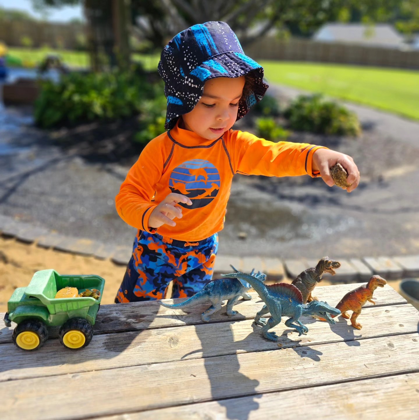 playing with dinosaurs on the picnic table